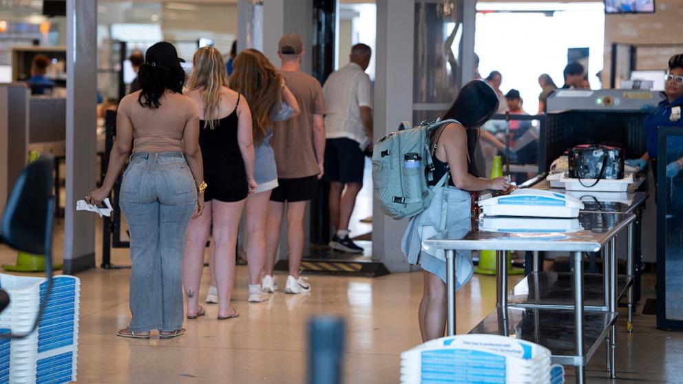 PHOTO: People enter a Transportation Security Administration security checkpoint at Philadelphia International Airport on July 8, 2025. 