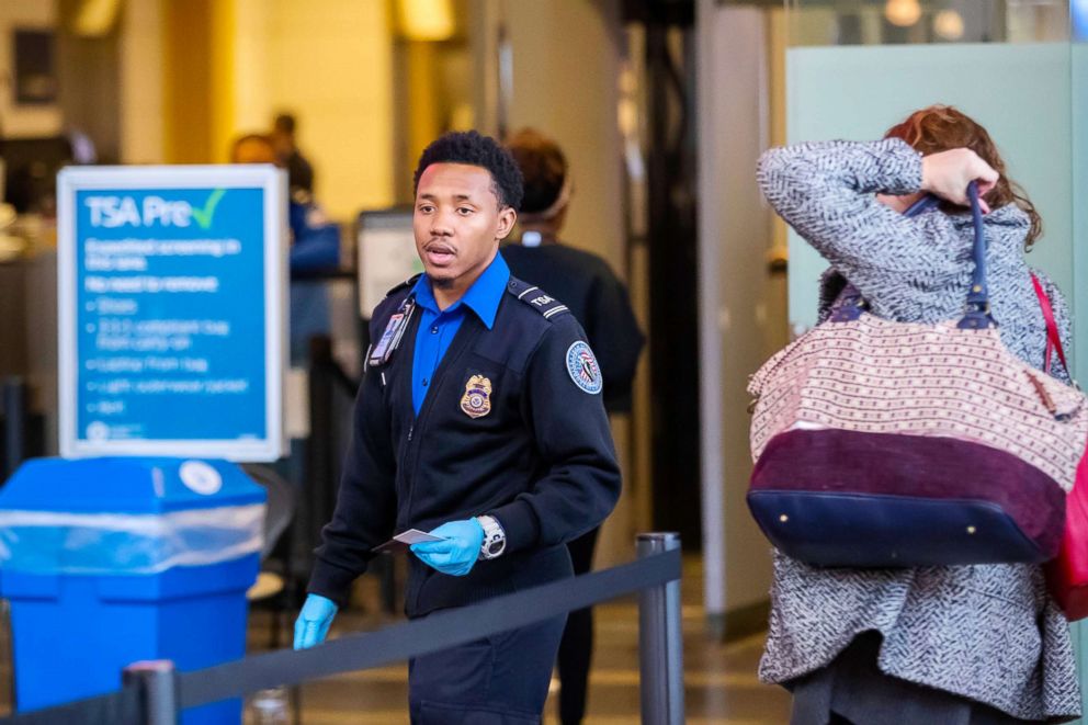 PHOTO:A Transportation Security Agency agent checks the identification of travelers at Ronald Reagan Washington National Airport in Arlington, Va.. Jan. 7, 2019.