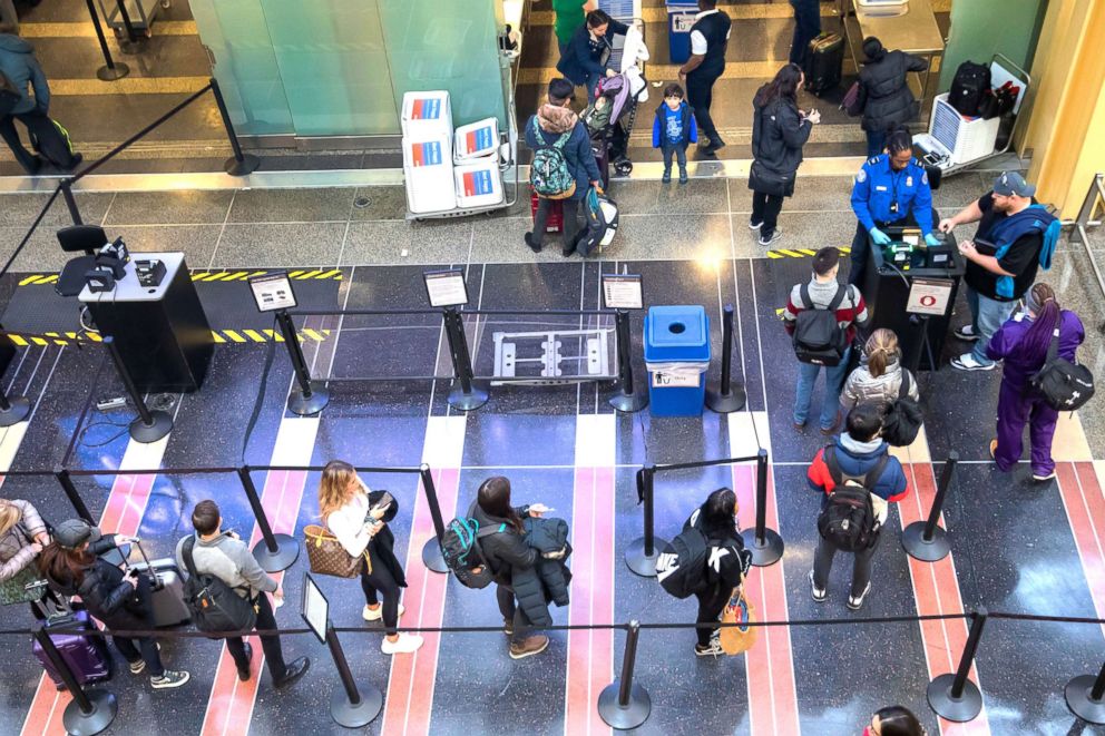 PHOTO: A Transportation Security Agency agent checks the identification of travelers at Ronald Reagan Washington National Airport in Arlington, Va., Jan. 7, 2019.