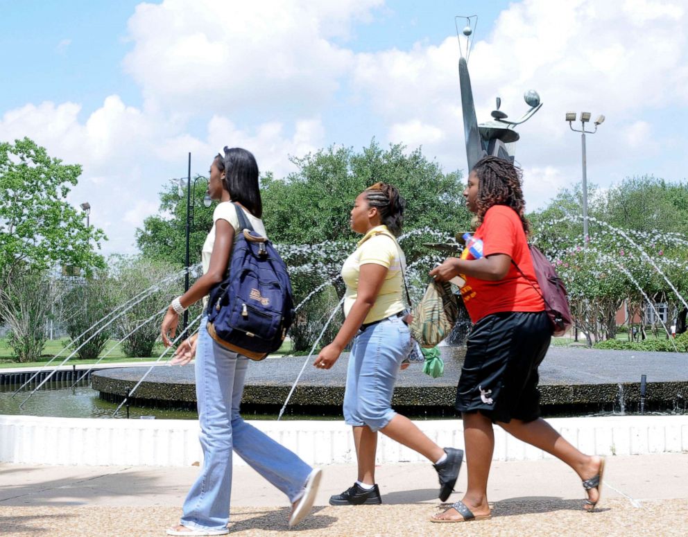 PHOTO: Students walk past the fountain at the Martin Luther King humanities building on the campus of Texas Southern University, July 9, 2008, in Houston.