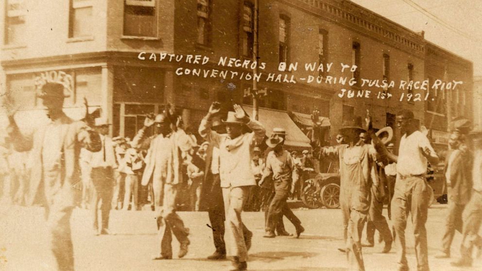 PHOTO: A group of Black men are marched past the corner of 2nd and Main Streets under armed guard during the Tulsa Race Massacre in Tulsa, Okla., on June 1, 1921.