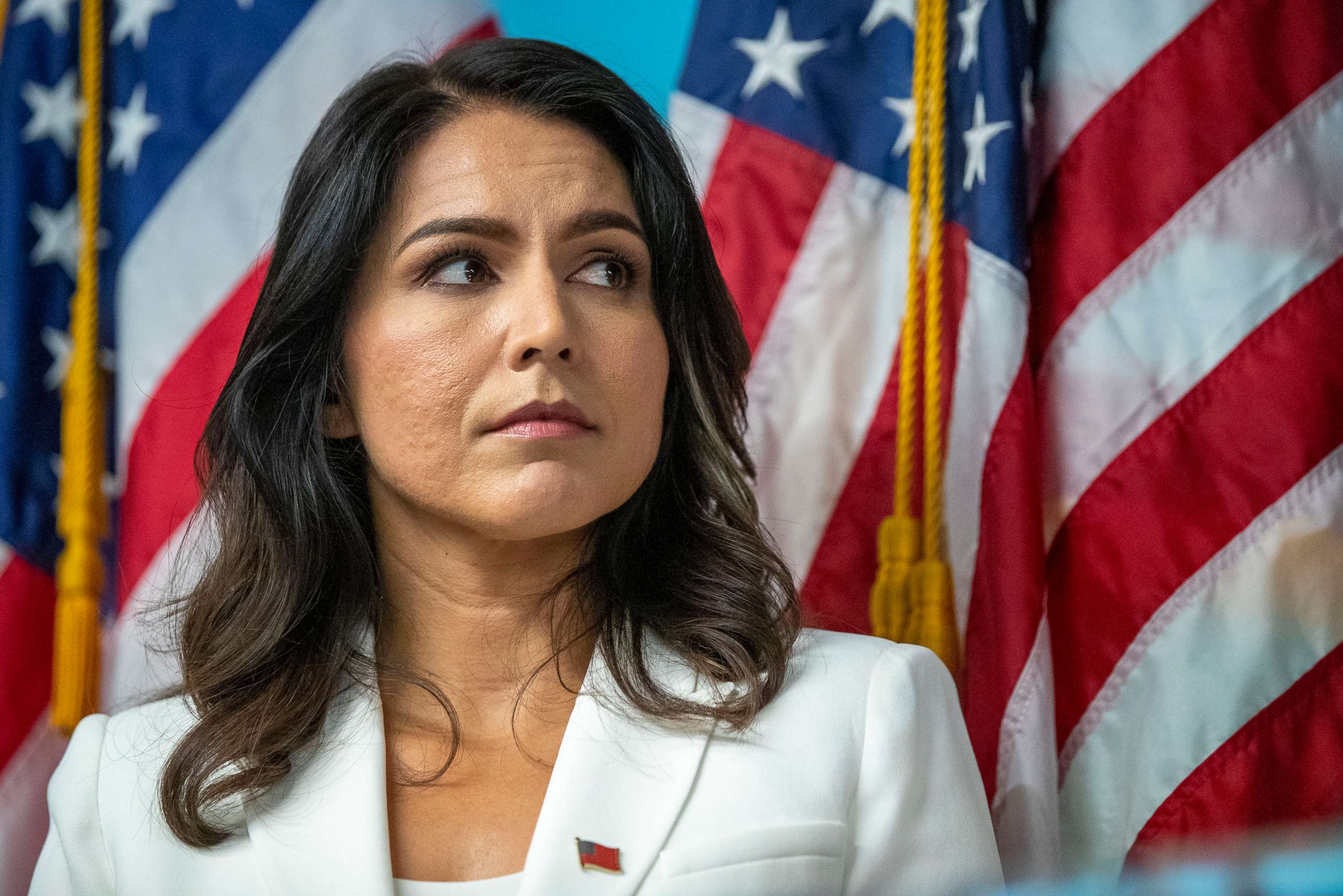 PHOTO: Democratic presidential candidate U.S. Rep. Tulsi Gabbard listens as family members of victims of the terrorist attacks on 9/11 speak during a news conference at the 9/11 Tribute Museum, Oct. 29, 2019, in New York.