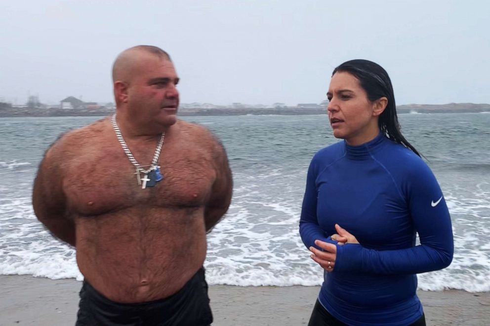 PHOTO: Presidential candidate, Tulsi Gabbard speaks with Chuck Rosa after taking the Polar Bear plunge in Seabrook, N.H., Jan. 1, 2020.