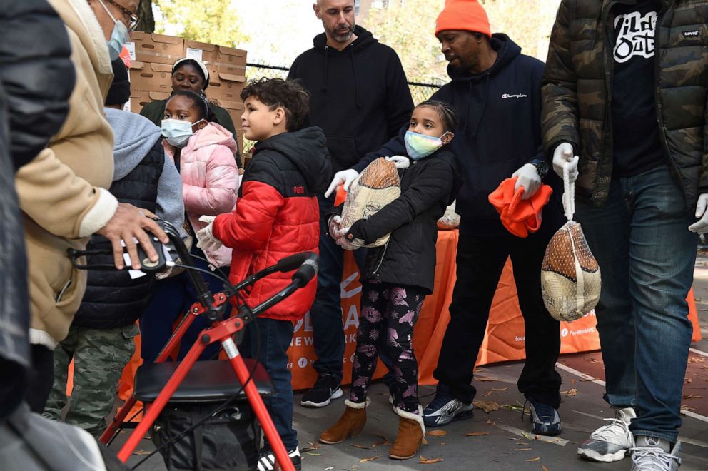 PHOTO: People collect turkeys during a Food Bank For New York City Team Up To Distribute Food At Sumner Houses In Brooklyn Ahead Of Thanksgiving on Nov. 13, 2021, in Brooklyn, New York