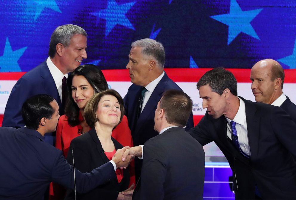 PHOTO: Chuck Todd of NBC News greets Sen. Amy Klobuchar, former housing secretary Julian Castro, former Texas congressman Beto O'Rourke and other candidates after the first night of the Democratic presidential debate on June 26, 2019, in Miami.