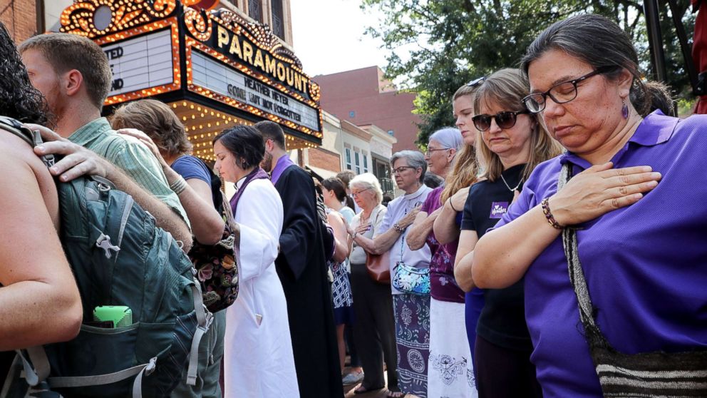 PHOTO: Clergy observe a moment of silence during the memorial service for Heather Heyer outside the Paramount Theater, Aug. 16, 2017 in Charlottesville, Va.