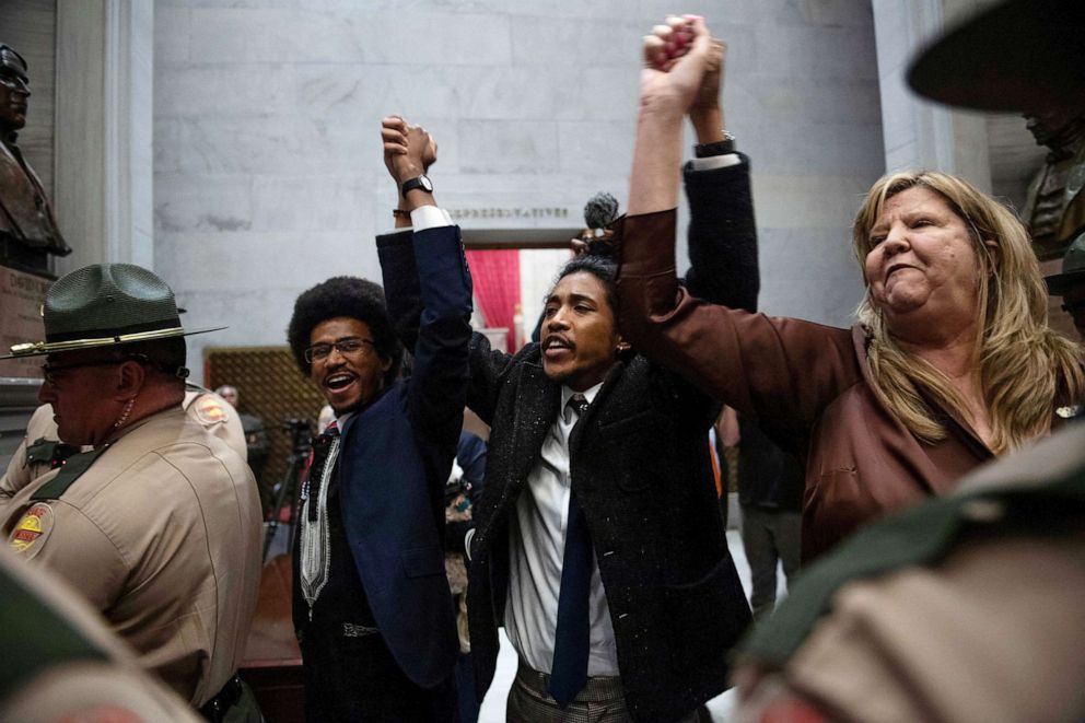 PHOTO: Tennessee Reps. Justin Pearson, Justin Jones and Gloria Johnson hold hands as they exit the House Chamber at the Tennessee State Capitol building, April 3, 2023, in Nashville.