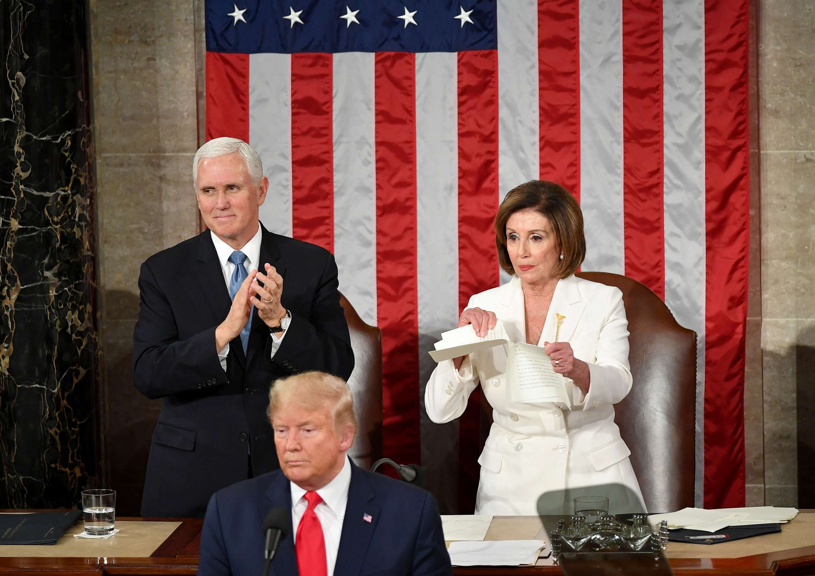 PHOTO: Vice President Mike Pence claps as Speaker of the House of Representatives Nancy Pelosi rips a copy of President Donald Trump's speech after he delivers the State of the Union address in Washington, D.C., Feb. 4, 2020.