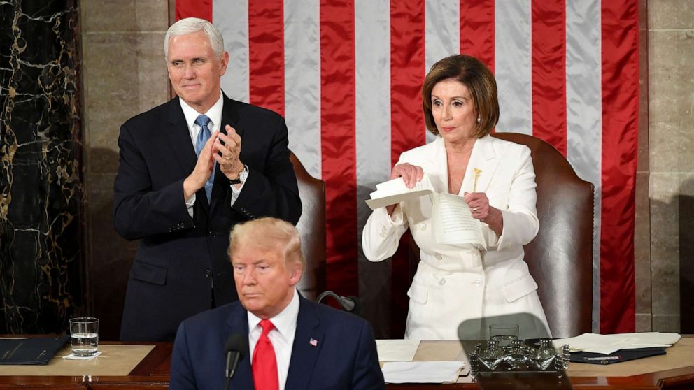 PHOTO: Vice President Mike Pence claps as Speaker of the House of Representatives Nancy Pelosi rips a copy of President Donald Trump's speech after he delivers the State of the Union address in Washington, DC, Feb.  4, 2020.