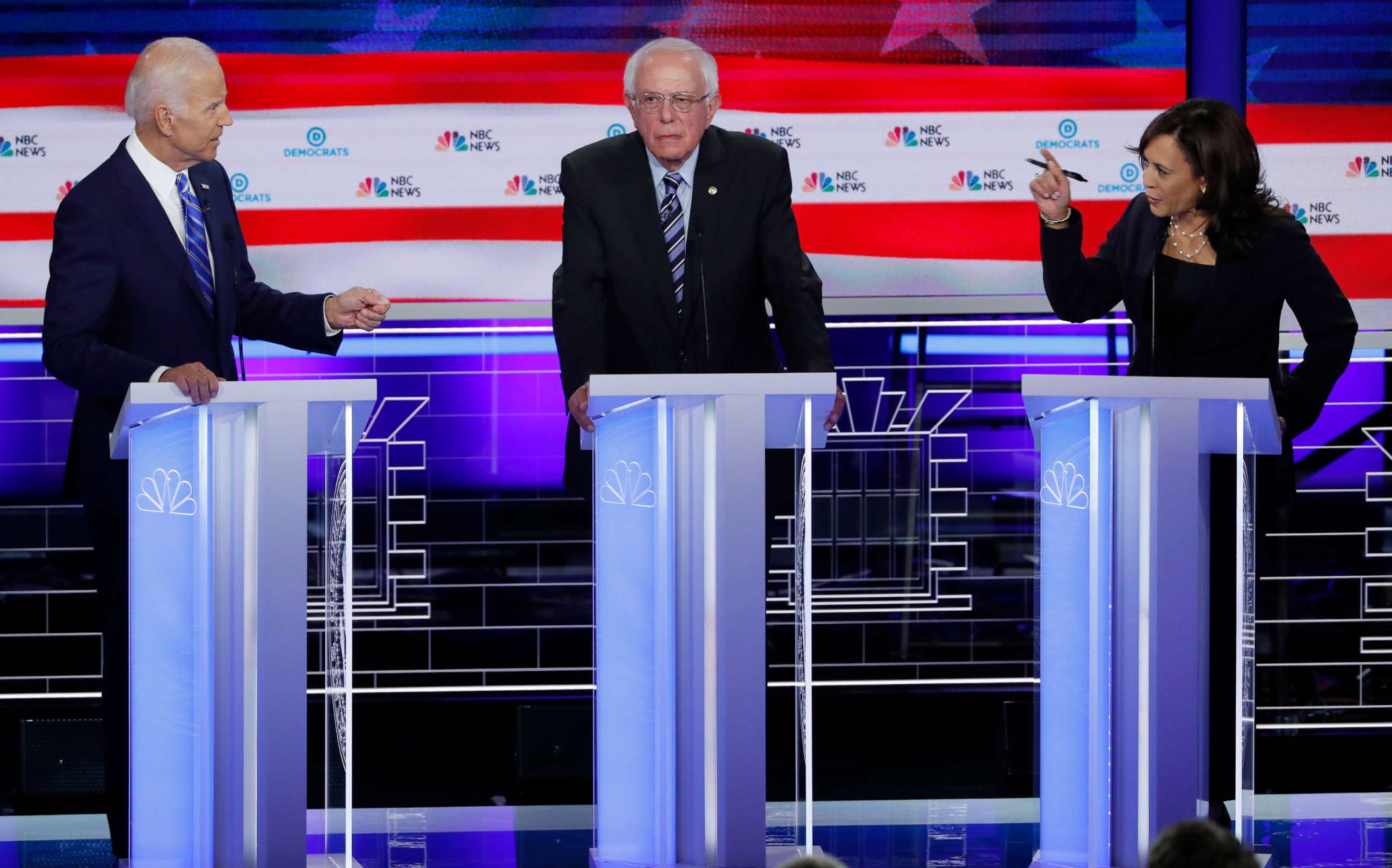 PHOTO: Former Vice President Joe Biden defends his record on race issues against Sen. Kamala Harris as Sen. Bernie Sanders listens during the second night of the first Democratic presidential 2020 election debate in Miami, June 27, 2019. 