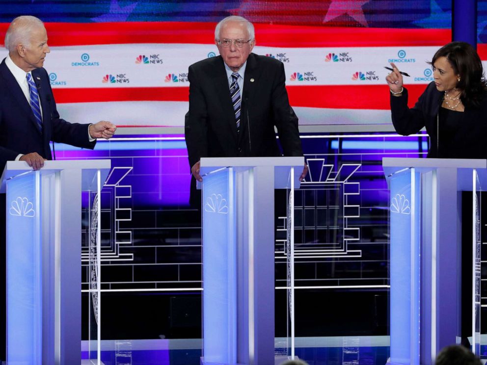 PHOTO: Former Vice President Joe Biden defends his record on race issues against Sen. Kamala Harris as Sen. Bernie Sanders listens during the second night of the first Democratic presidential 2020 election debate in Miami, June 27, 2019.