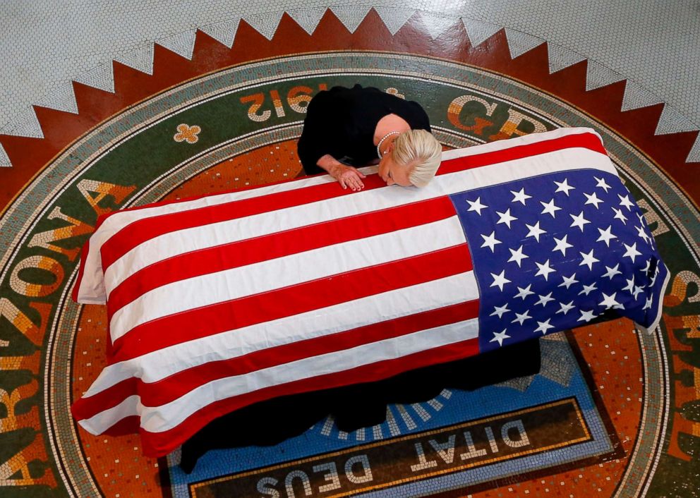 PHOTO: Cindy McCain, wife of US Senator John McCain, kisses his casket during a memorial service at the Arizona Capitol, Aug. 29, 2018, in Phoenix.