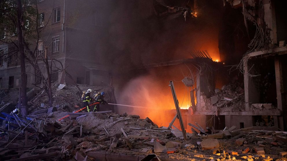 PHOTO: Firefighters try to put out a fire following an explosion in Kyiv, Ukraine, April 28, 2022. Russia mounted attacks across a wide area of Ukraine on Thursday, bombarding Kyiv during a visit by the head of the United Nations. 