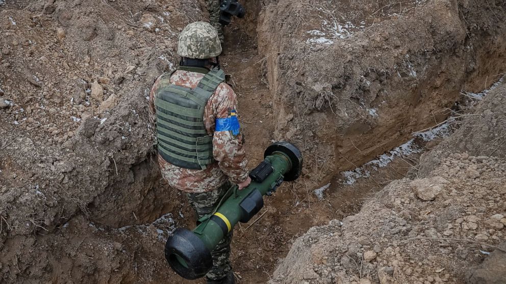 PHOTO: A Ukrainian service member walks along a trench with a Javelin missile system at a position on the front line in the north Kyiv region, Ukraine, March 13, 2022.