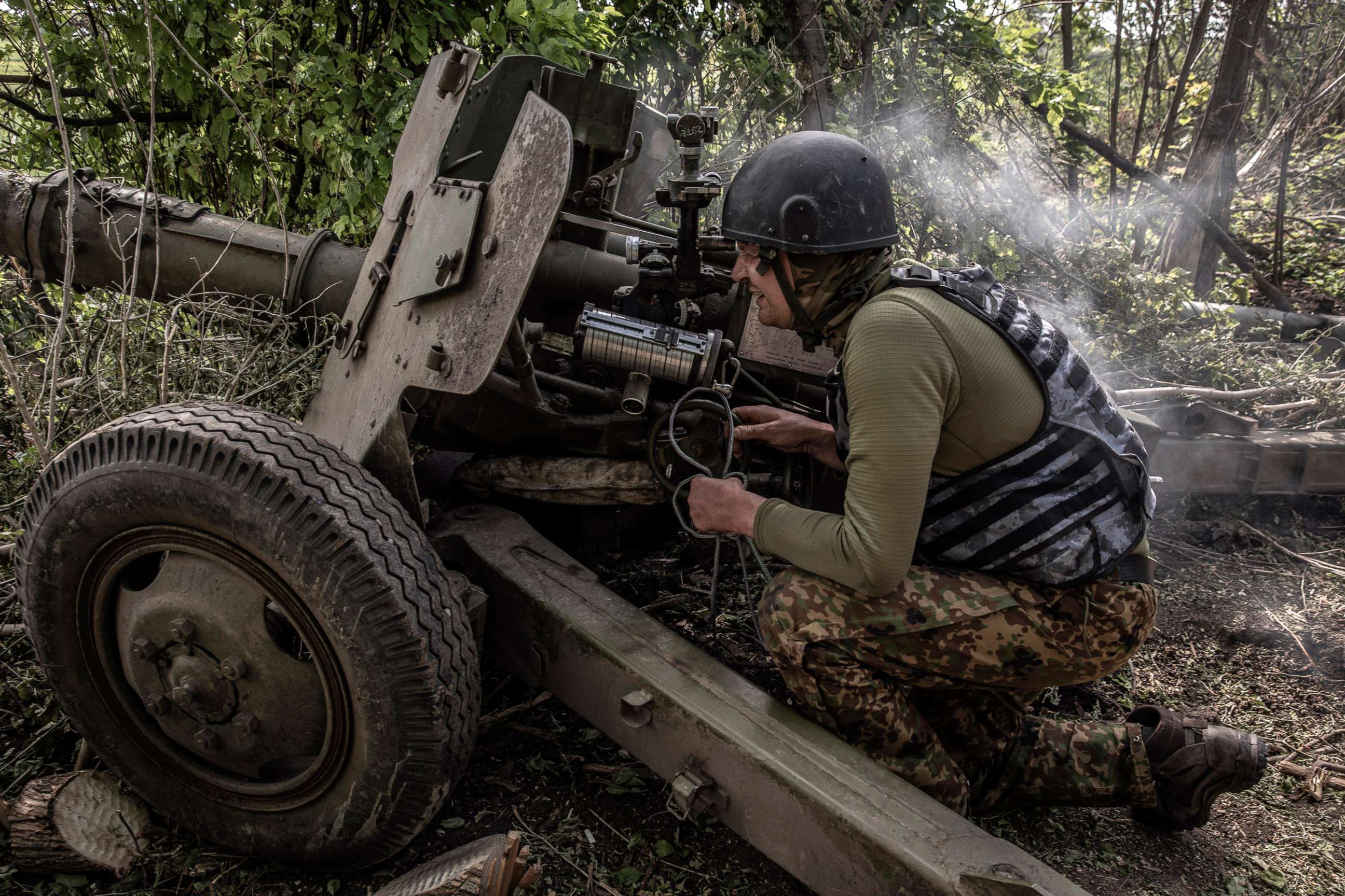 PHOTO: A Ukrainian artillery gunner adjusts his sights after firing on Russian troops a few miles away near the village of Vuhledar, in eastern Ukraine, on May 31, 2022.