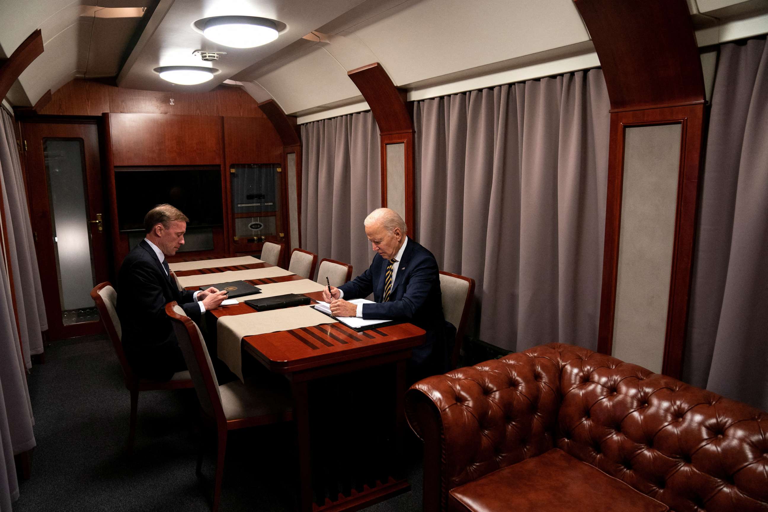 PHOTO: President Joe Biden sits on a train with National Security Advisor Jake Sullivan as he goes over his speech marking the one-year anniversary of the war in Ukraine after a surprise visit with Ukrainian President Zelenskiy, Feb. 20, 2023, in Kyiv.