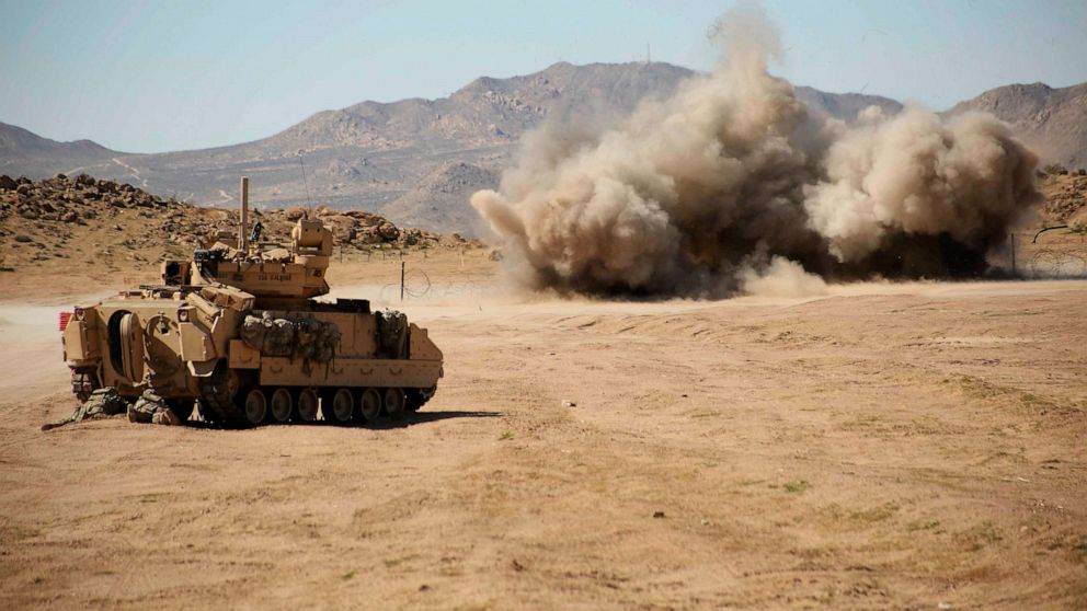 PHOTO: U.S. Soldiers, assigned to the 2nd Brigade, 1st Cavalry Division, 1st Squadron, 9th Cavalry Regiment, take cover as a Bangalore Torpedo Demolition Charge explodes in Fort Irwin, Calif., Feb 19, 2017.