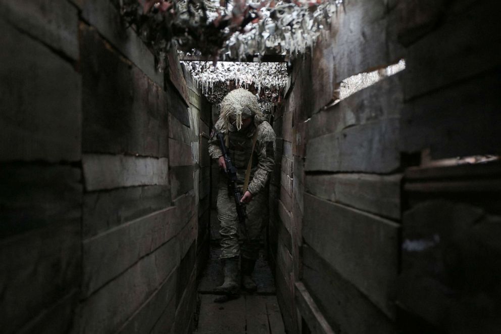 PHOTO: Ukrainian soldier walks along a trench on the frontline with Russia-backed separatists, not far from town of Avdiivka, Donetsk region, Dec. 10, 2021. 