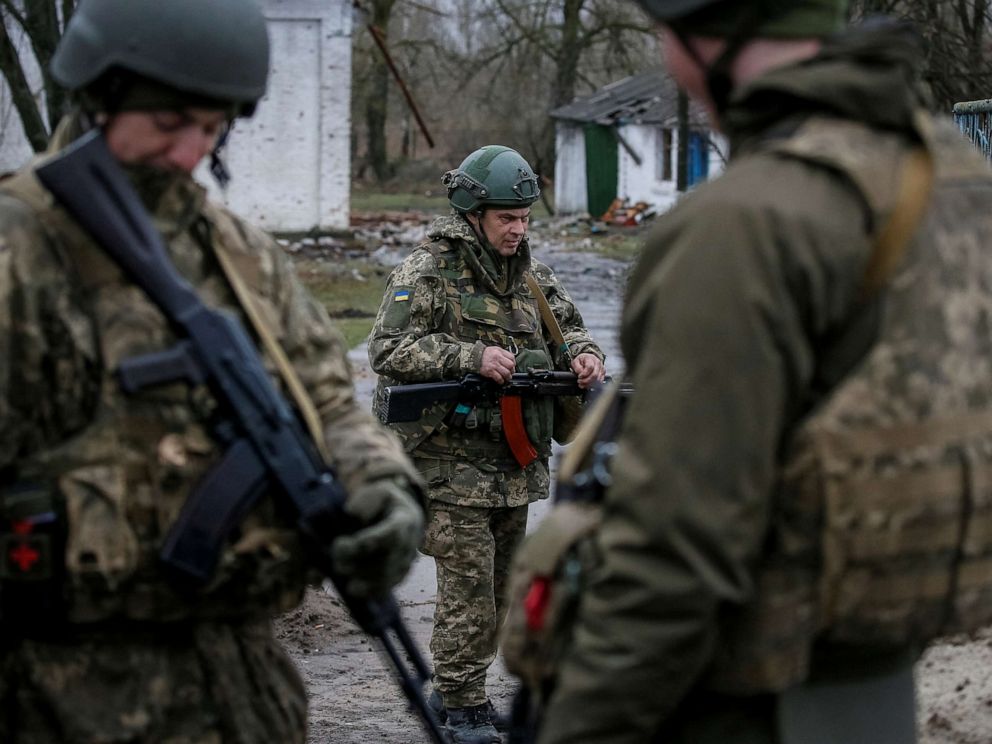 PHOTO: Ukrainian service members hold their weapons, amid Russia's invasion of Ukraine, near the village of Kozarovychi , in Kyiv region, Ukraine April 2, 2022.  