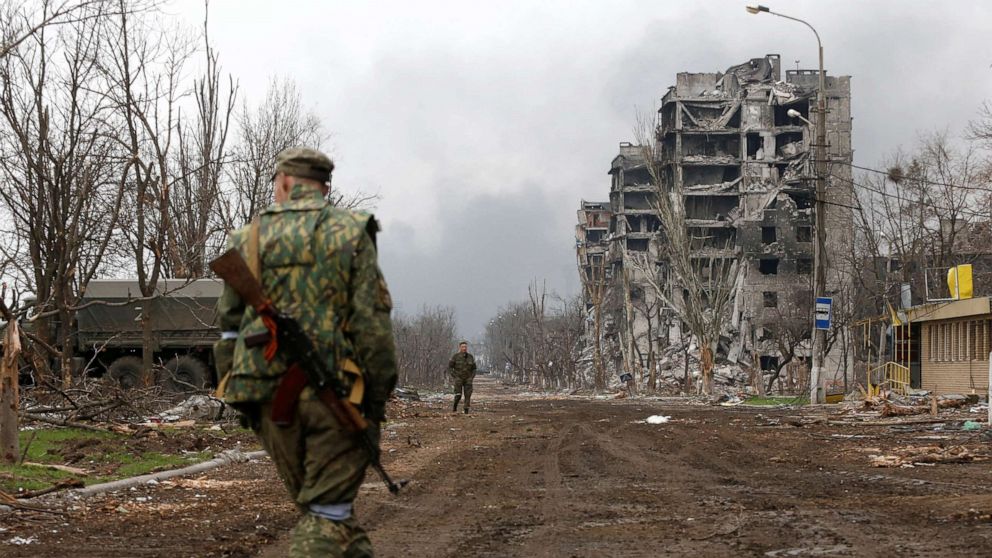 PHOTO: Service members of pro-Russian troops walk in the street during fighting in Ukraine-Russia conflict near a plant of Azovstal Iron and Steel Works company in the southern port city of Mariupol, Ukraine April 12, 2022.
