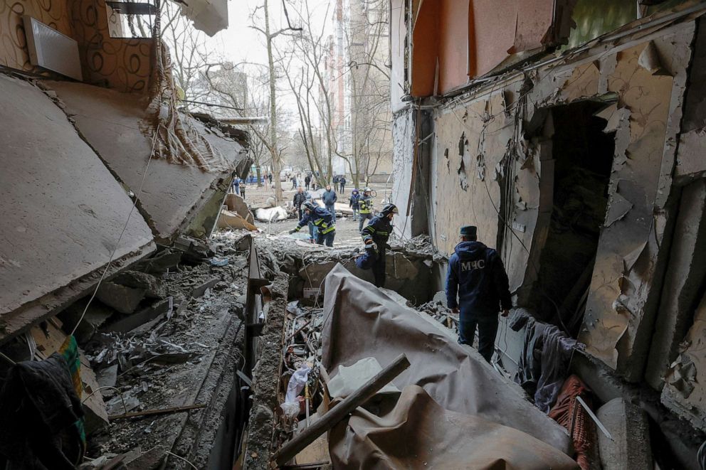PHOTO: Members of a local emergencies ministry take part in a rescue and search operation in a multi-storey apartment block damaged in recent shelling in the course of Russia-Ukraine conflict in Donetsk, Ukraine, March 28, 2023.