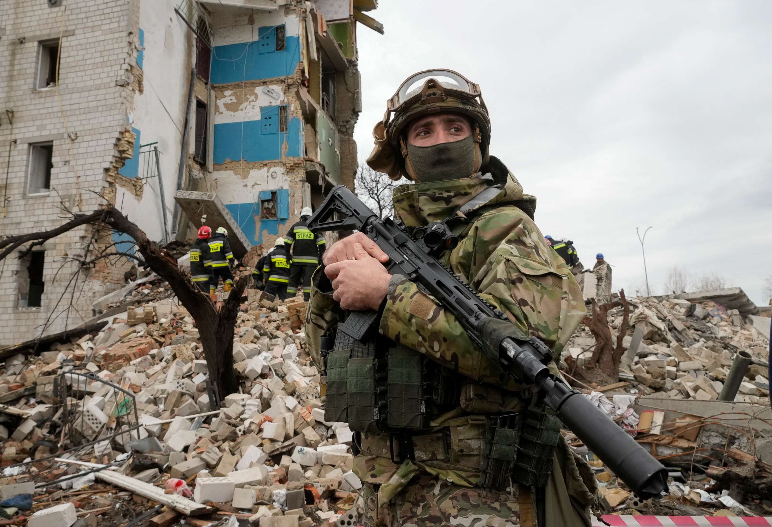 PHOTO: A Ukrainian soldier stands against the background of an apartment house ruined in the Russian shelling in Borodyanka, Ukraine, on Apr. 6, 2022.