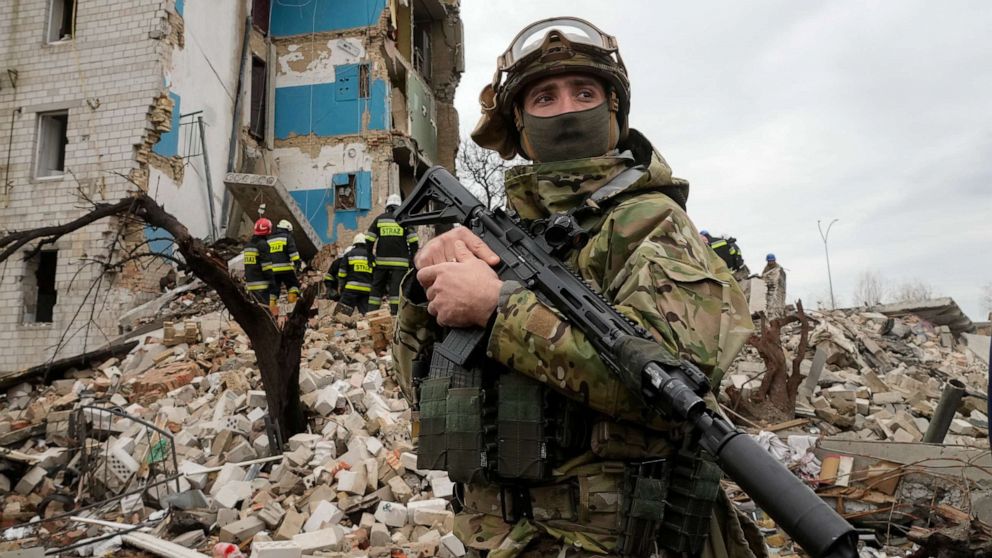PHOTO: A Ukrainian soldier stands against the background of an apartment house ruined in the Russian shelling in Borodyanka, Ukraine, on Apr. 6, 2022.