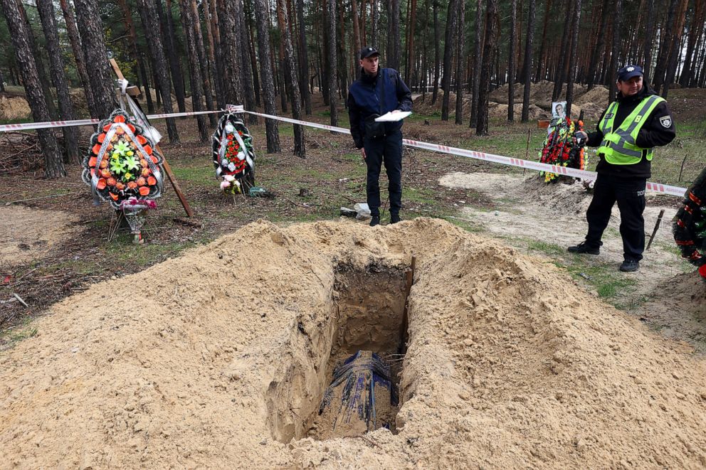 PHOTO:  Investigators research the killing of three Izium residents as a car was shelled when the Russian convoy entered Izium in March 2022, Izium, Kharkiv Region, northeastern Ukraine, Oct. 31, 2022.