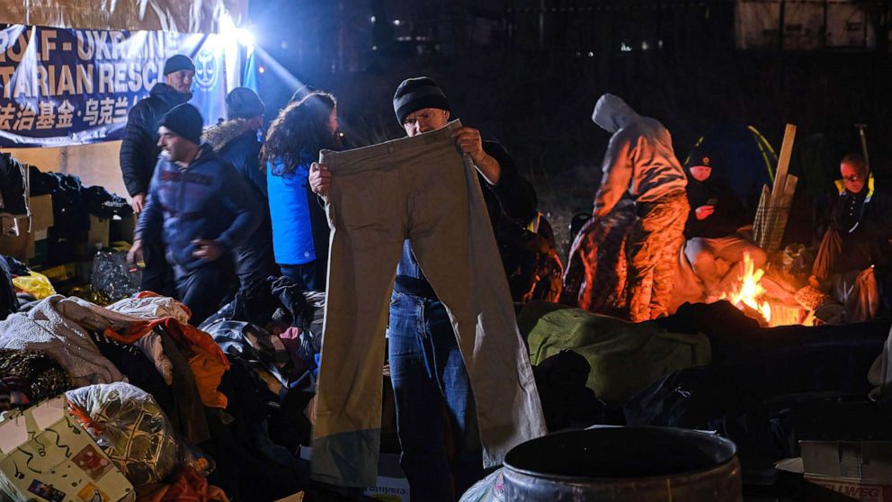 PHOTO: A Ukrainian refugee looks for some clothes in the Medyka refugee camp March 17, 2022. The war in Ukraine has forced millions of Ukrainians to leave their country destroyed in a horrendous war.
