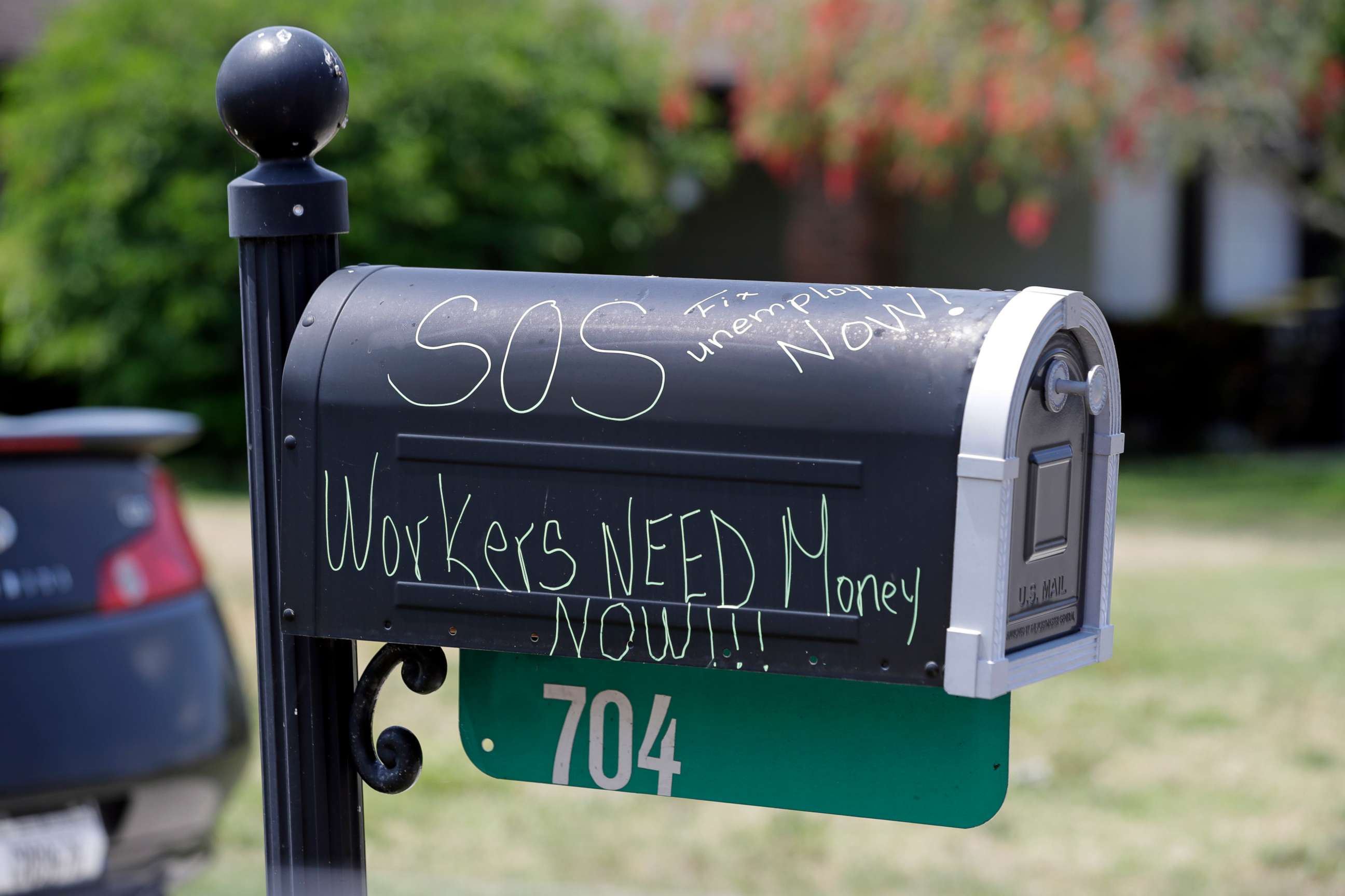 PHOTO: A plea for help is written on the mailbox of the home of a recently furloughed employee of Disney World, April 13, 2020, in Kissimmee, Fla.