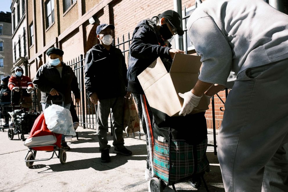 PHOTO: People receive food during a distribution to those struggling with unemployment during the Covid-19 pandemic in New York, Oct. 17, 2020.