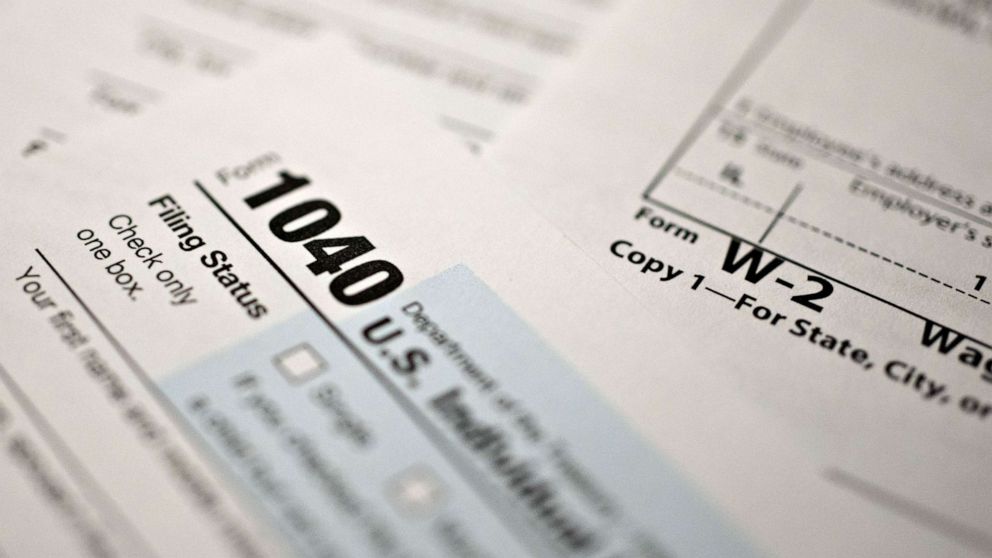 PHOTO: A U.S. Department of the Treasury Internal Revenue Service (IRS) 1040 Individual Income Tax sits with a W-2 wage statement in Tiskilwa, Ill., March 20, 2020. 