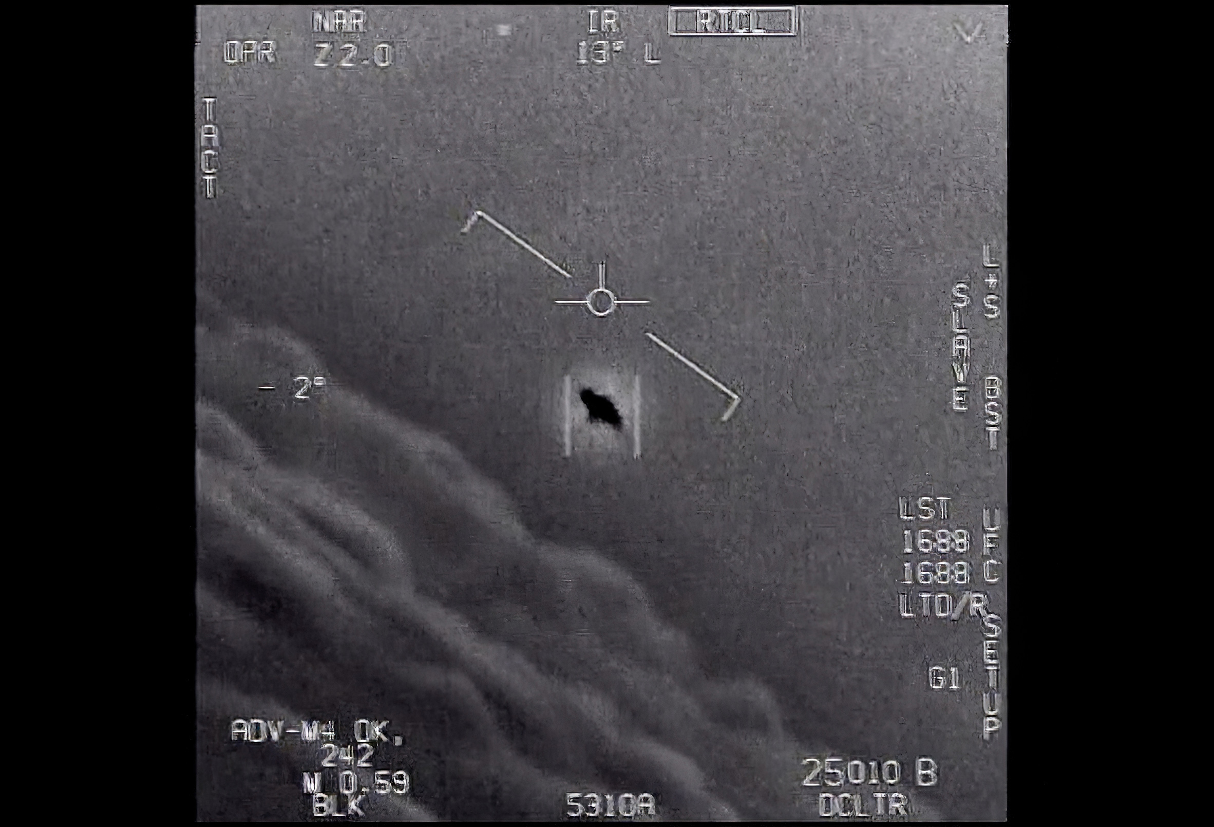 PHOTO: The image from video provided by the Department of Defense labelled Gimbal, from 2015, an unexplained object is seen at center as it is tracked as it soars high along the clouds, traveling against the wind.