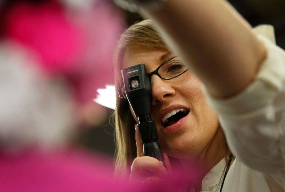 PHOTO: A doctor performs an eye test on a child at a health clinic for the uninsured and underinsured Los Angeles, Sept. 27, 2012.
