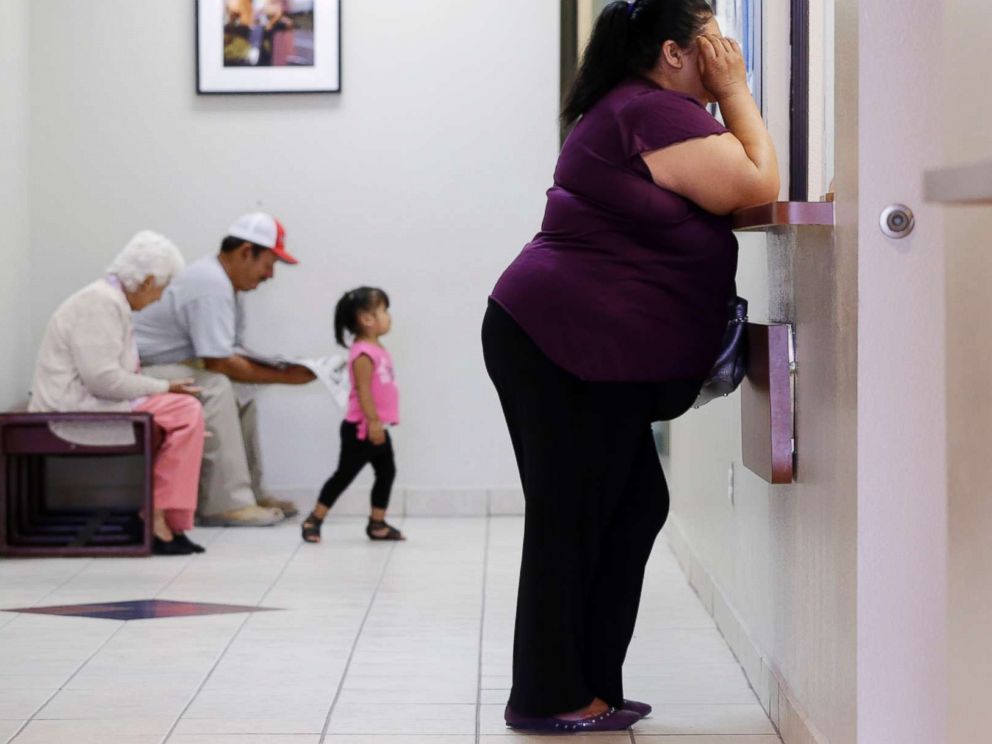 PHOTO: In this July 12, 2012 photo, a woman stands at the registration window at Nuestra Clinica Del Valle in San Juan, Texas.