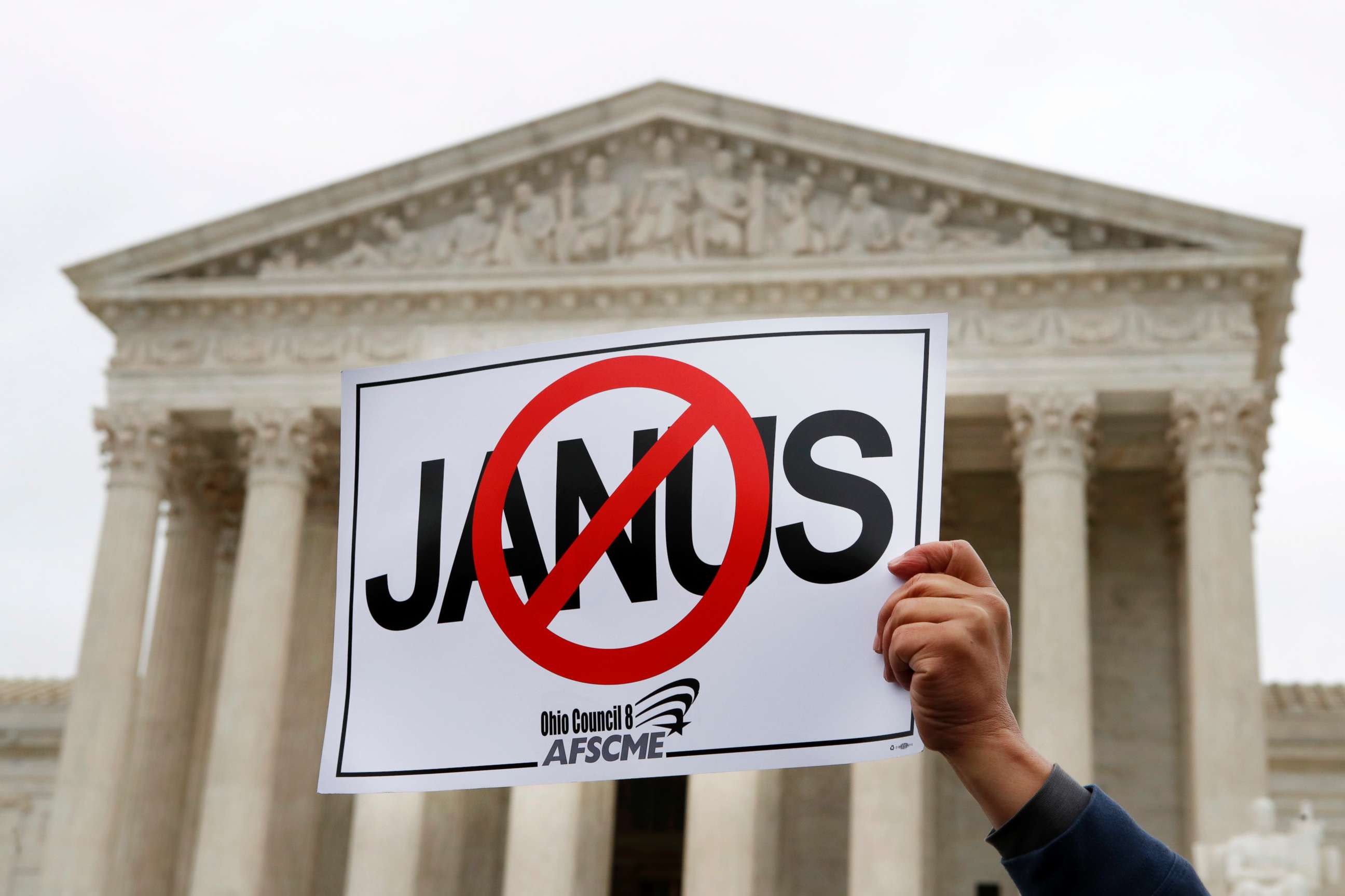 PHOTO: Stephen Roberts, with the American Federation of State, County and Municipal Employees (AFSCME), holds up a sign against Mark Janus during a rally outside of the Supreme Court, Monday, Feb. 26, 2018, in Washington D.C. 