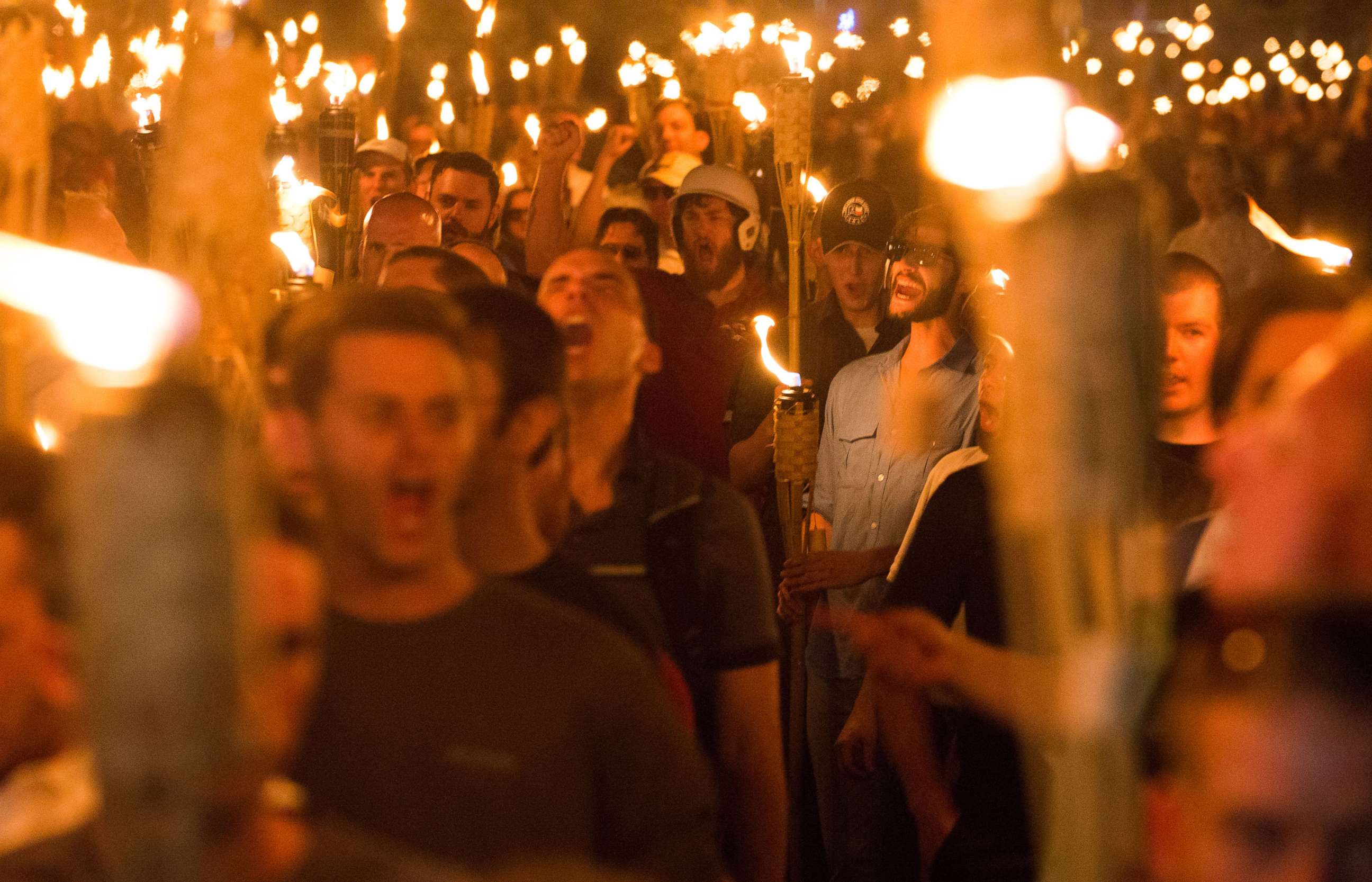 PHOTO: The night before the 'Unite the Right' rally in Charlottesville, Va., men march with tiki torches through the University of Virginia campus, Aug. 11, 2017.  