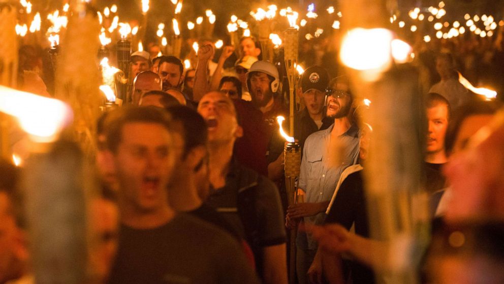 PHOTO: The night before the 'Unite the Right' rally in Charlottesville, Va., men march with tiki torches through the University of Virginia campus, Aug. 11, 2017.  