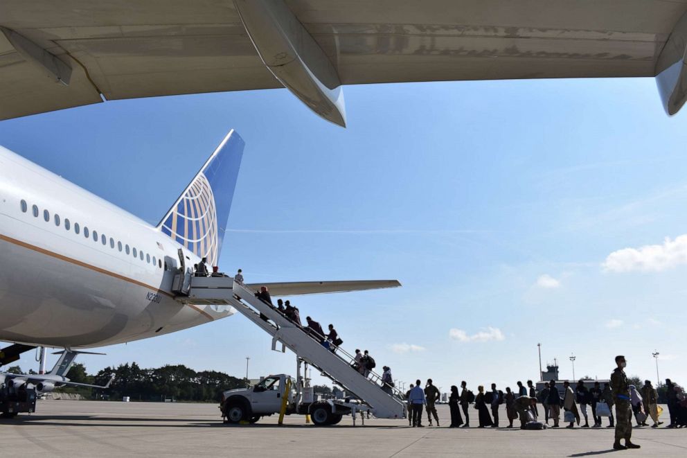 PHOTO: Afghan evacuees board a United Airlines plane at Ramstein Airbase in Germany, Aug. 25, 2021.