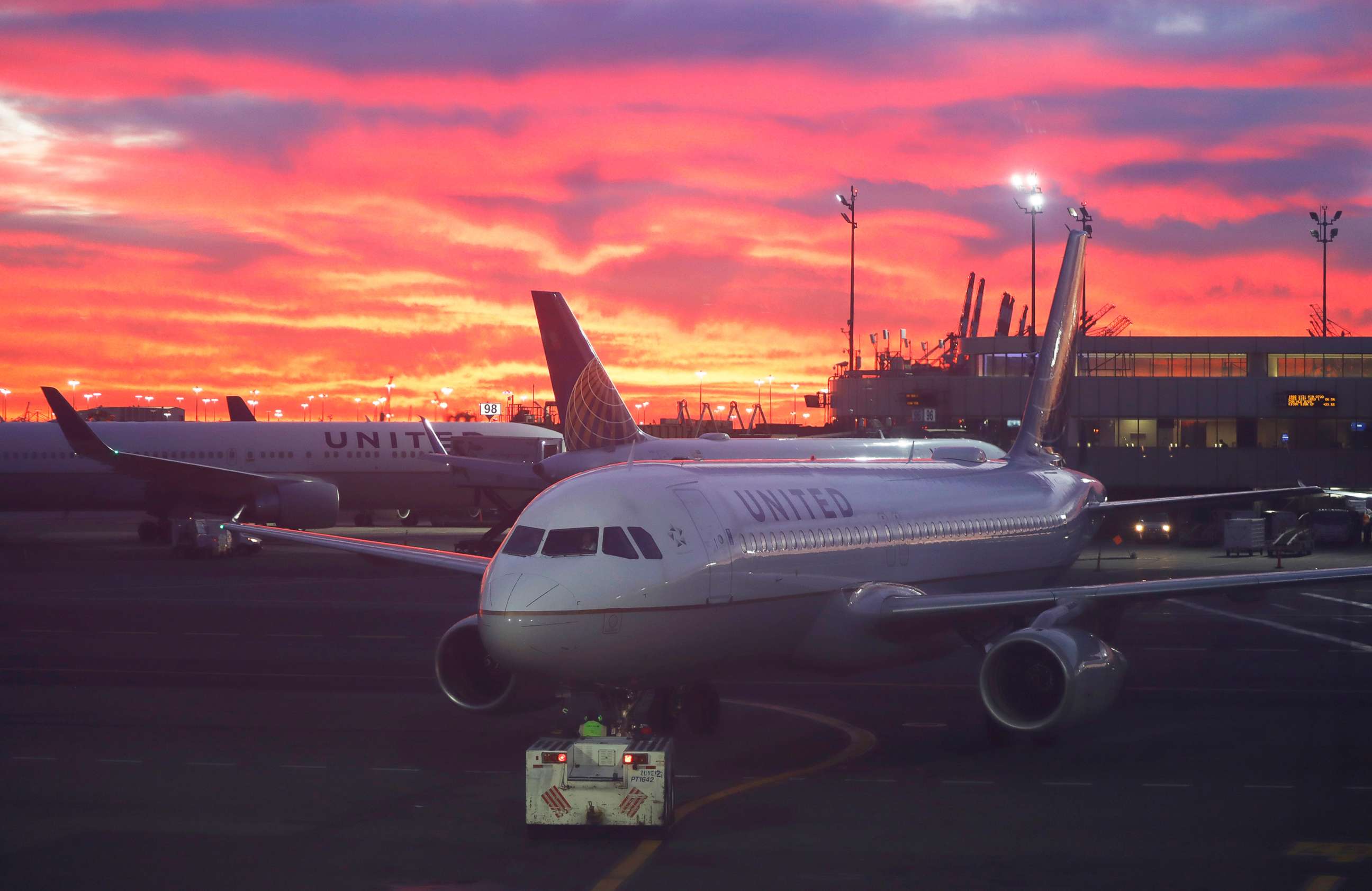 PHOTO: A United Airlines airplane is pushed back from its gate at Newark Liberty International Airport as the sun rises in Newark, N.J., Dec. 13, 2021.