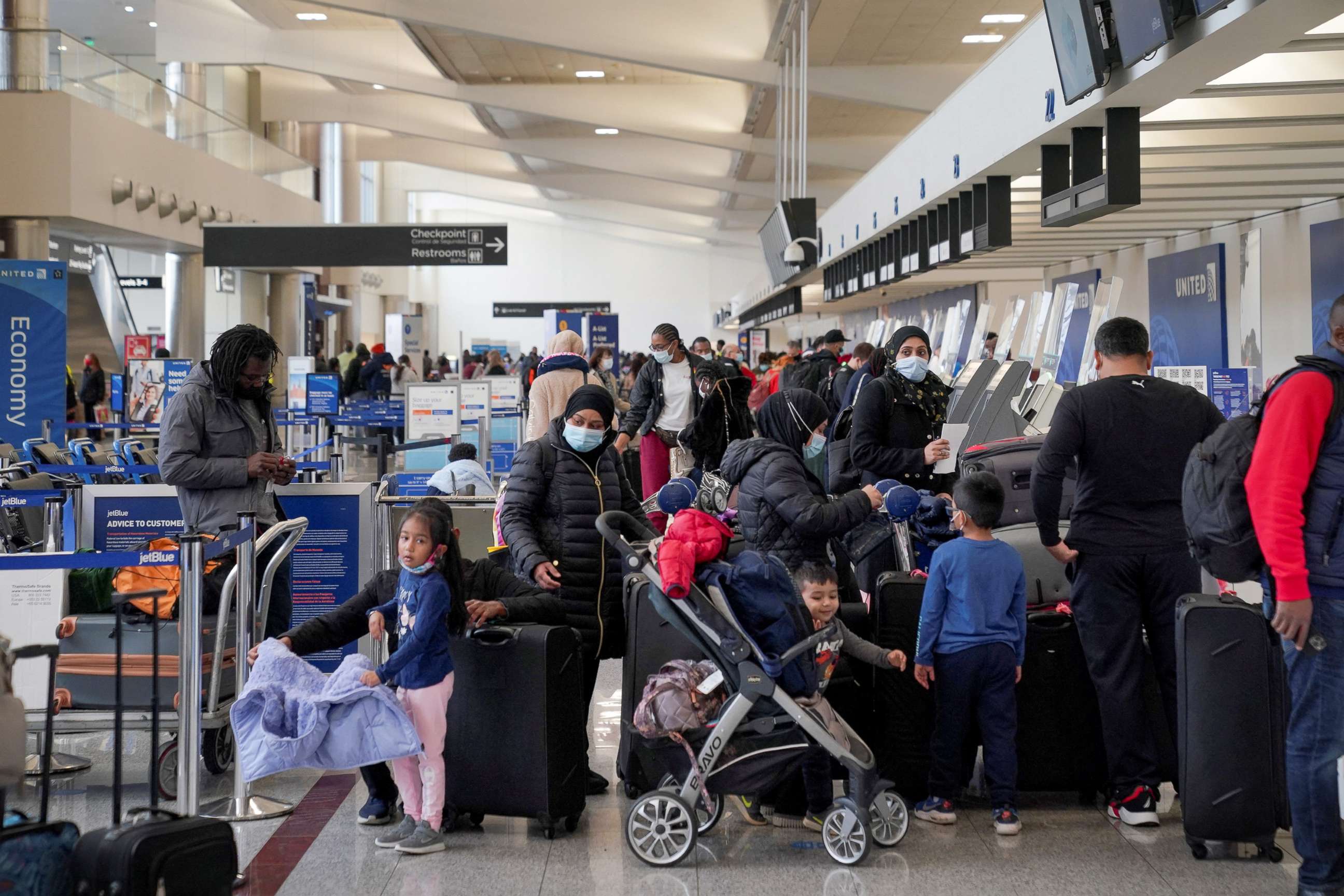 PHOTO: People wait in line to check in at the United Airlines ticket counter at Hartsfield-Jackson Atlanta International Airport in Atlanta, Dec. 20, 2021.