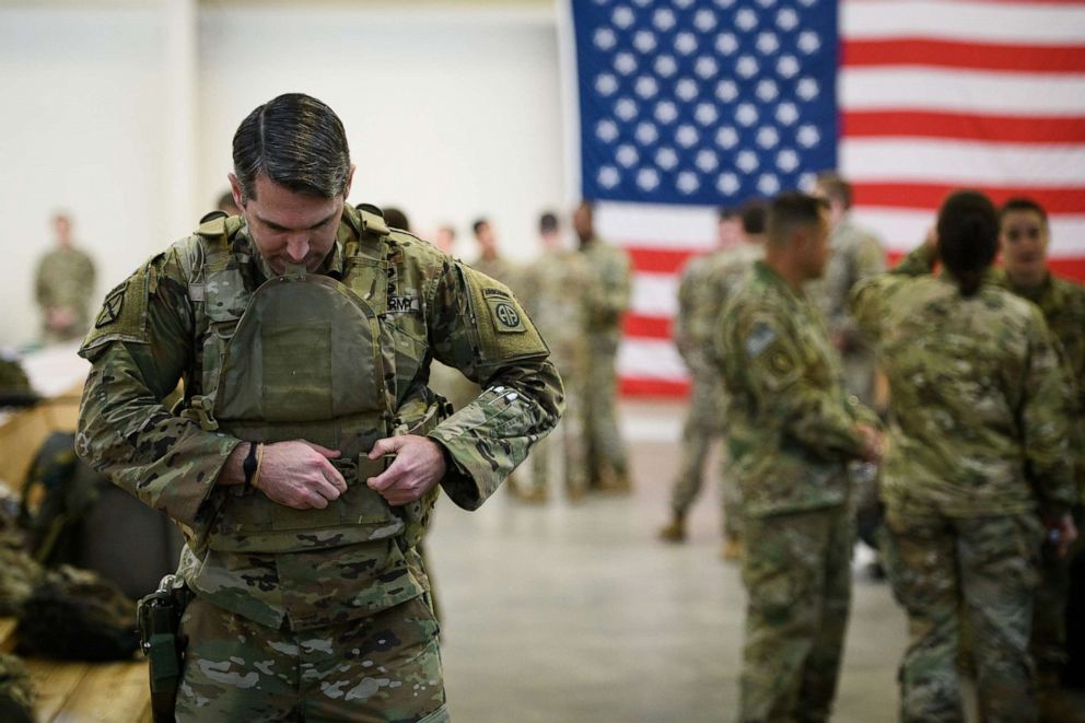 PHOTO: U.S. troops from the Army's 82nd Airborne Division wait at Green Ramp before they head out for a deployment to the Middle East on Jan. 4, 2020 in Fort Bragg, N.C.