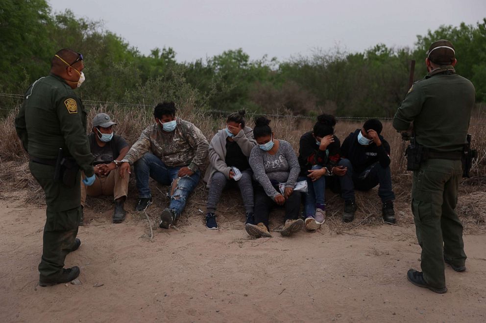 PHOTO: U.S. Border Patrol agents process a group of people they caught crossing the border from Mexico, March 27, 2021, in Penitas, Texas. 