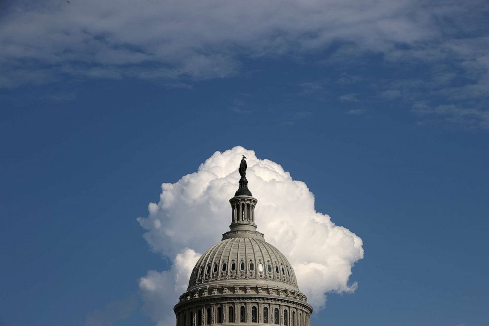 A cloud rises behind the U.S. Capitol on Aug. 13, 2021 in Washington.