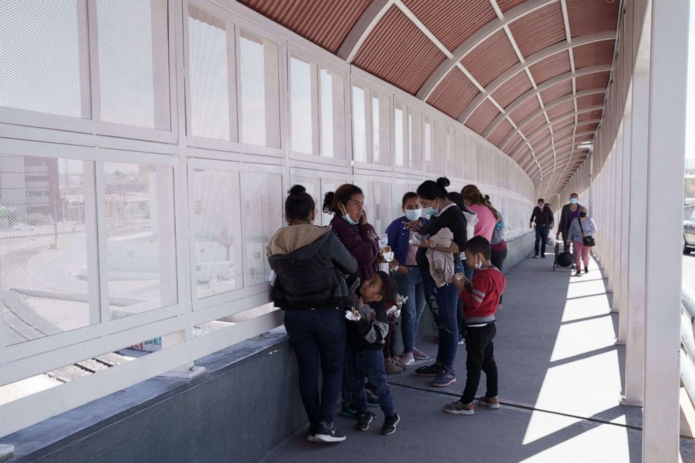 PHOTO: A group of migrants rapidly deported from the US under Title 42 wait on the Mexican side of the Paso del Norte International Bridge, between El Paso, Texas and Ciudad Juarez, Mexico on March 10, 2021. 