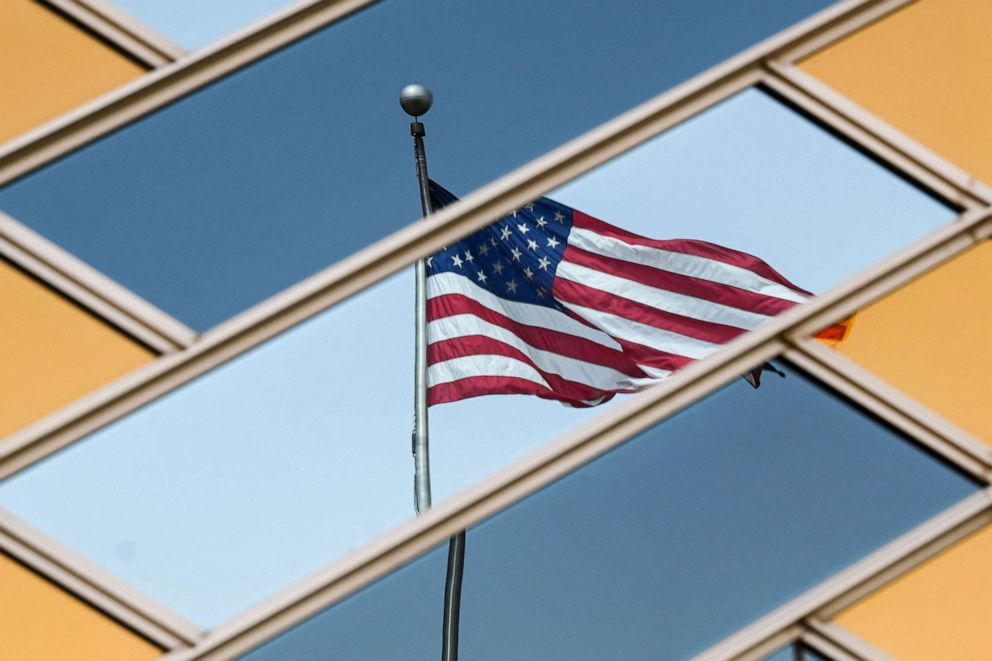 PHOTO: The American flag is reflected on the windows of the U.S. embassy building in Kabul on July 30, 2021.