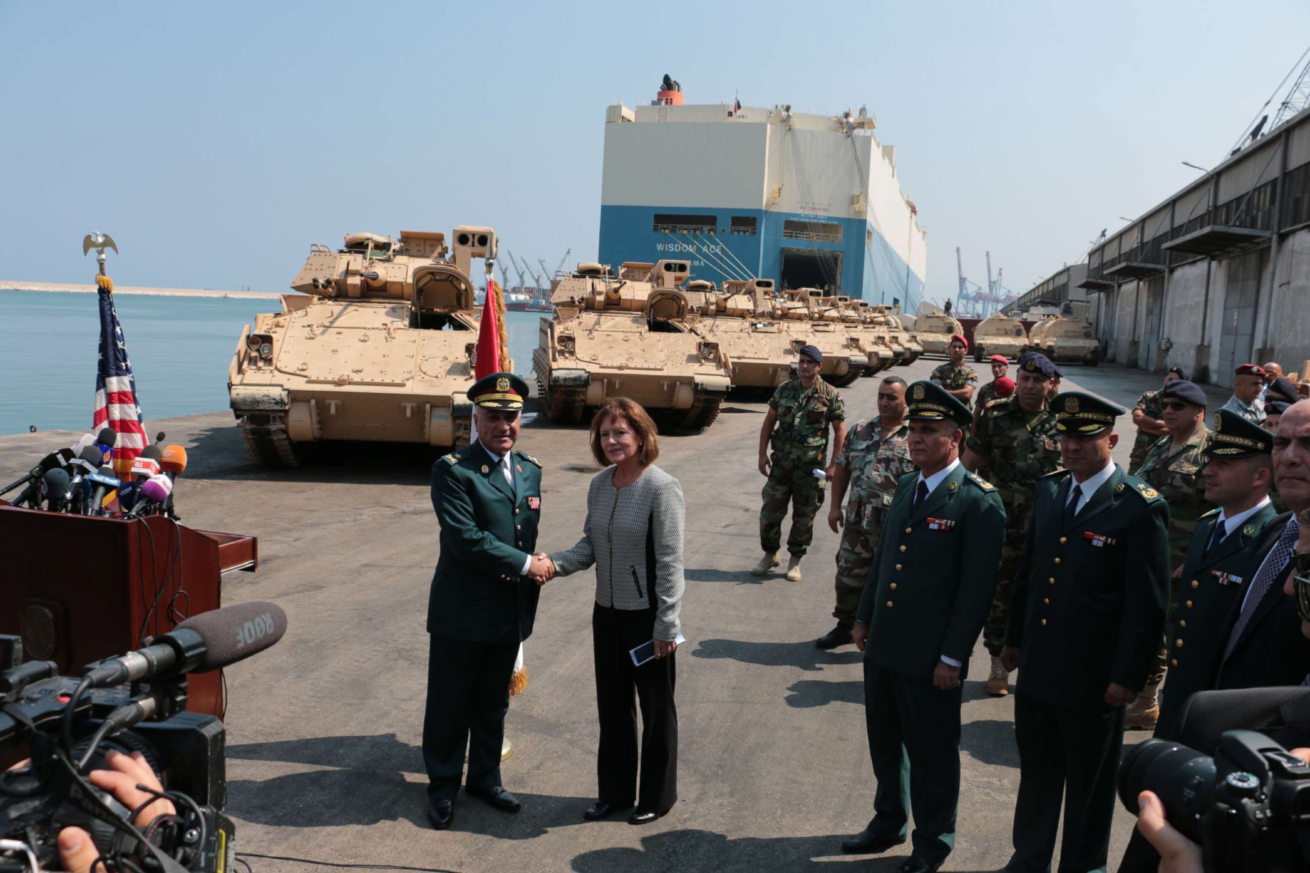 PHOTO: Elizabeth Richard, U.S. Ambassador to Lebanon, right, and official army members attend a ceremony of armored military vehicles are unloaded from ships at Beirut's port in Lebanon on Aug. 14, 2017.