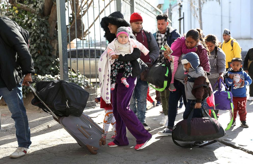 PHOTO: A group of people wait to cross the Paso Del Norte Port of Entry bridge to turn themselves in to the U.S. Customs and Border Protection personnel for asylum consideration on Jan. 13, 2019 in Ciudad Juarez, Mexico.