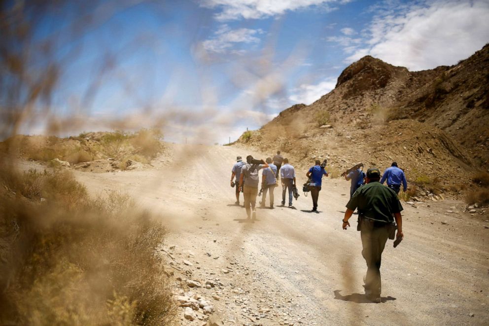 PHOTO: A U.S. Border Patrol agent walks with media representatives during the "Dangers of Crossing the Border" event, to warn of the dangers of illegally crossing the border between Mexico and the United States in Sunland Park, N.M., June 23, 2021.