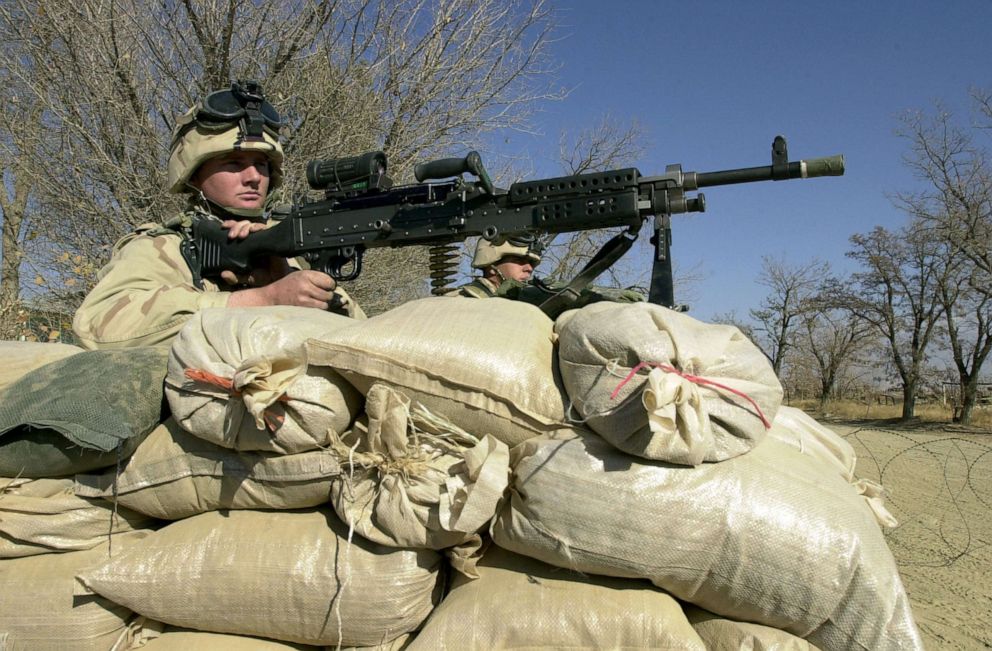 PHOTO: Two US Army soldiers guard a checkpoint, Dec. 1, 2001 at the Bagram airbase, north of Kabul, Afganistan.